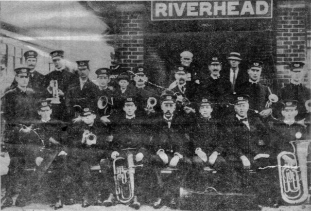 Riverhead Fire Department Band of 1910
Almost a century ago Riverhead had one of the outstanding bands in Suffolk County, which furnished music for parades and other affairs. The band accompanied the Riverhead Fire Department to the annual tournaments of the Suffolk County Volunteer Firemen's Association and the local vamps always made a splendid showing in parades.

This picture, taken on August 31, 1910 shows the members of the band and other &quot;tournament fans&quot; waiting at the Riverhead railroad station for the train to take them to Sayville where the tournament was held that year. Special trains to accommodate residents of all sections of the county to the community where the tournaments were held were operated in those days at a reduced fare. The tournament and the Suffolk County Fair then were the two big events of the year.

Shown in the picture, front row, from left to right - Clarence E Dugan, Forrest G &quot;Happy&quot; Downs, Carl A Hallett, J Fred Hallett, Harry Moore, Archibald Hallett and Carl S LeValley. Second row, from left to right - George L'Hommedieu, Fred S Hill, Hans Walty, Samuel Barber, Assistant Chief Nathan T Corwin, G Stanley Brown (boy), Lewis E Young, William Hall, Herbert L'Hommedieu, Matthias N Ammann and John Madden. Back row, from left to right - Chief Frank C Lane, Edward W Carter and Howard V Lane, the latter subsequently serving as one of the Commissioners of the Riverhead Fire District. At the extreme left (wearing a straw hat) is shown Lewis C Austin, late editor and publisher of the Riverhead News.